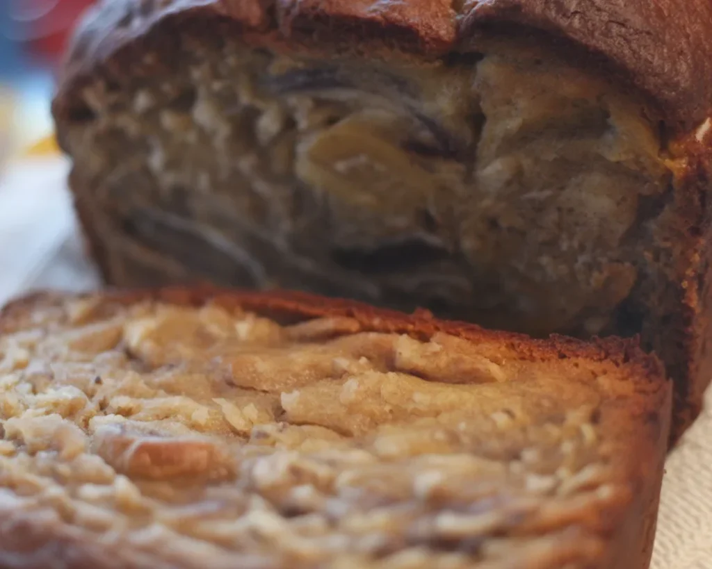 Slice of Janet's Rich Banana Bread with walnuts and a moist texture